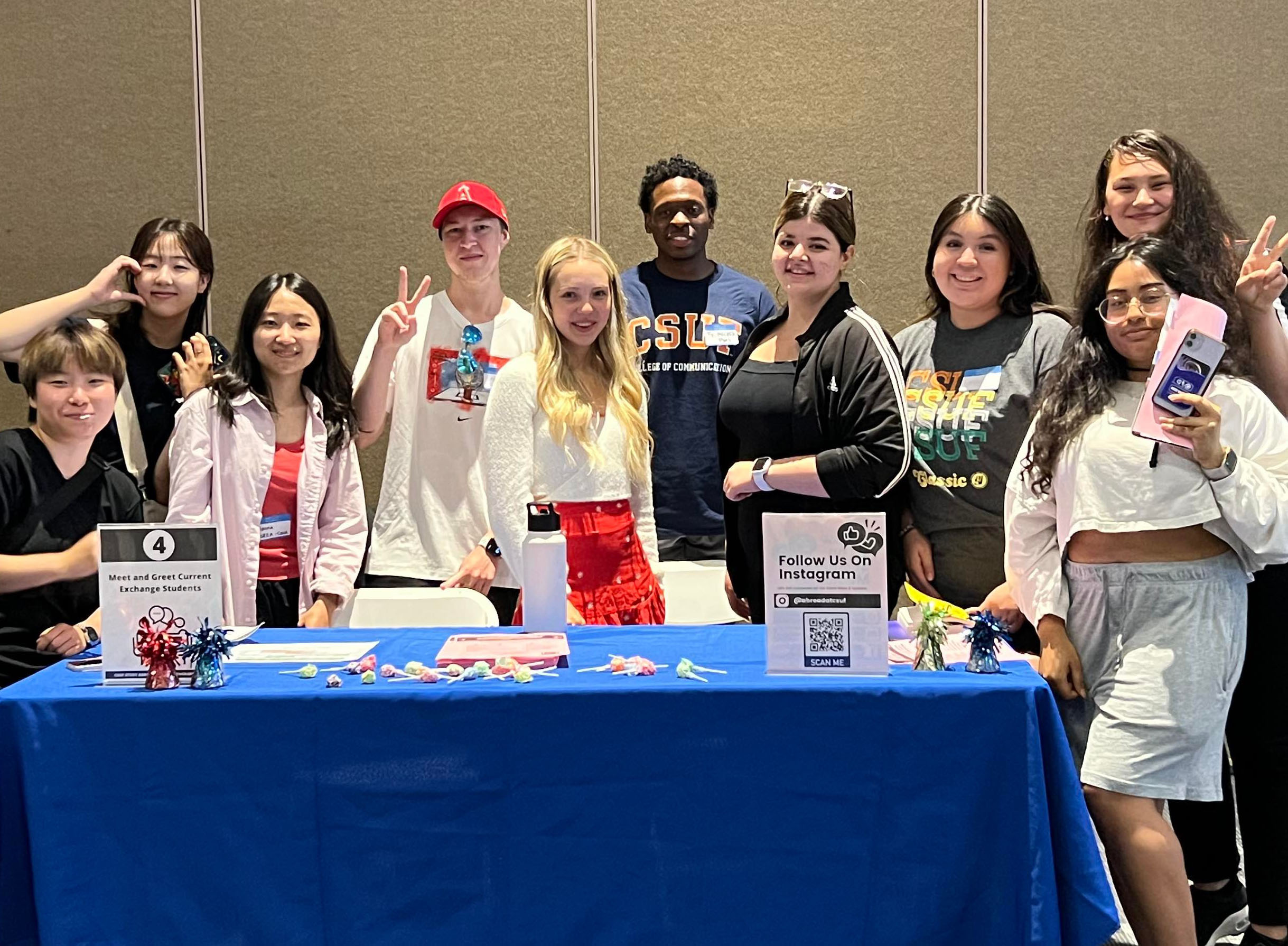students posing at a tabling event