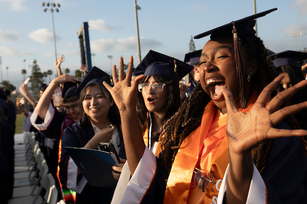3 students celebrating at commencement