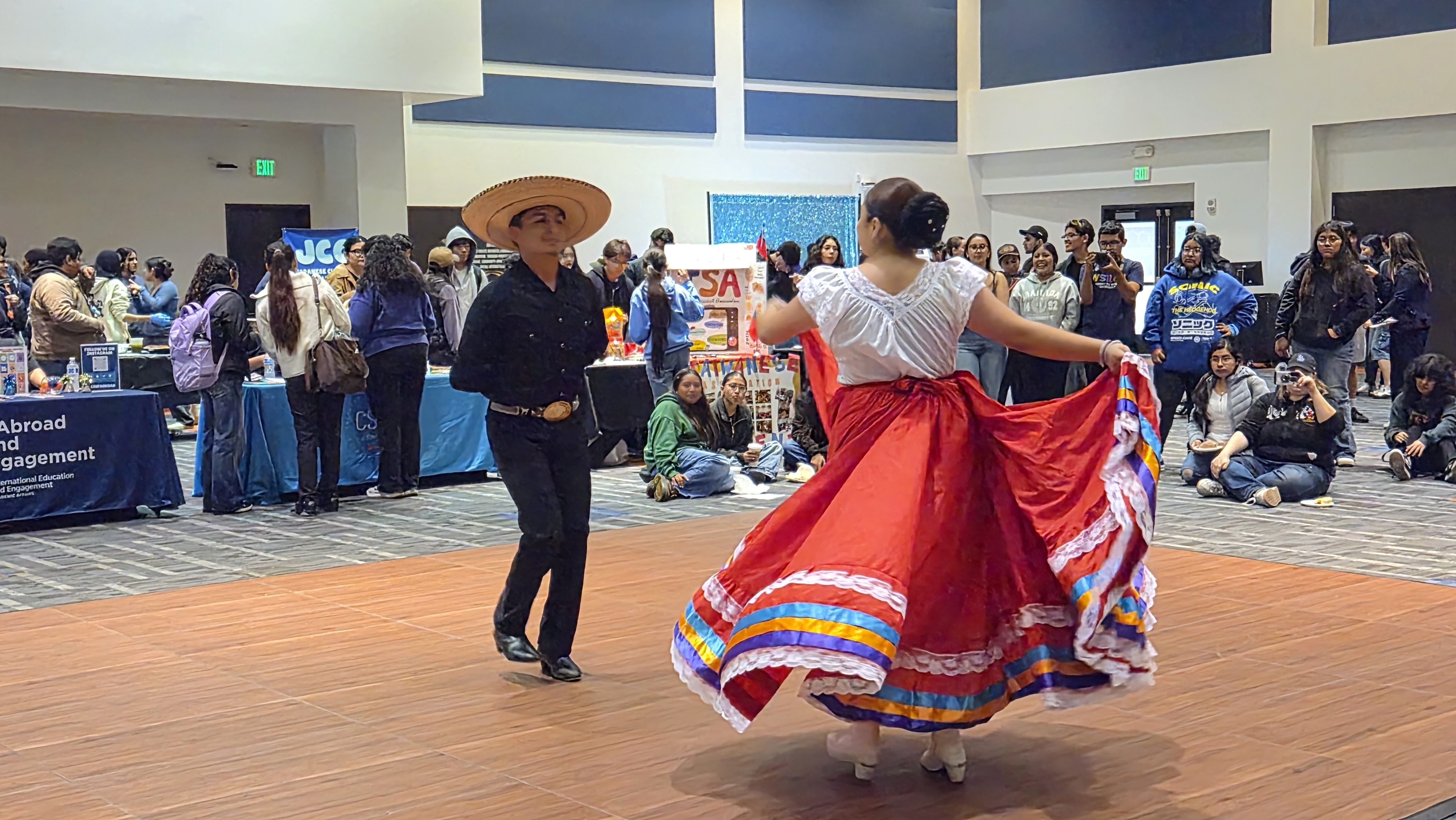 Two students performing cultural dance