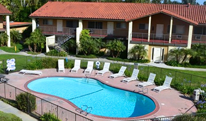 aerial view of apartment complex with pool